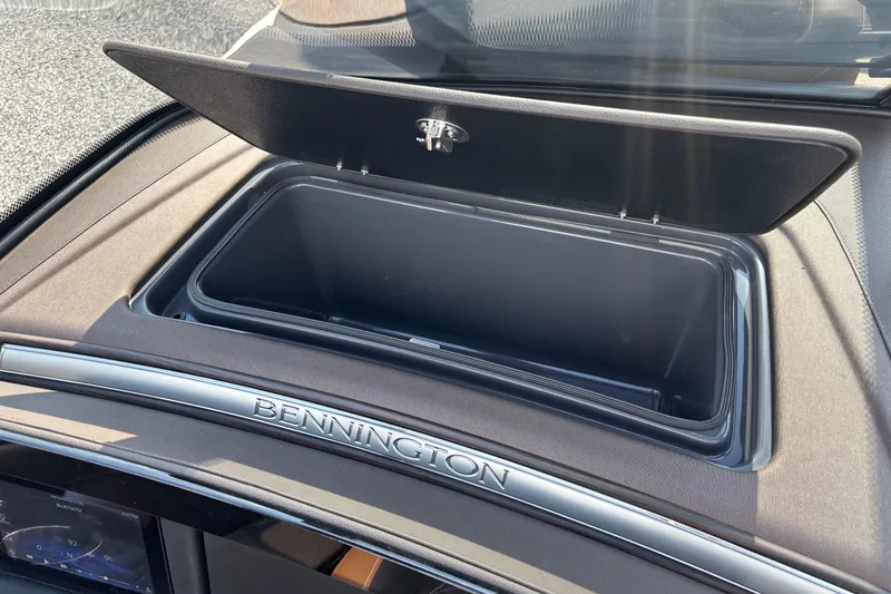 Slide: The Image of Bennington 27 QXFBWA T2 2026 storage compartment with open lid. - 23