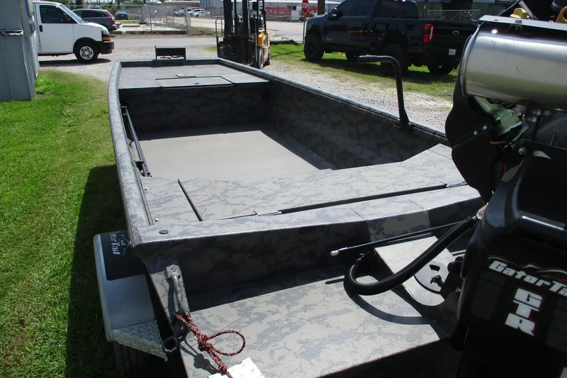 Slide: The Image of 2026 Gator Tail 1754 Extreme boat with camo design, parked outdoors. - 6