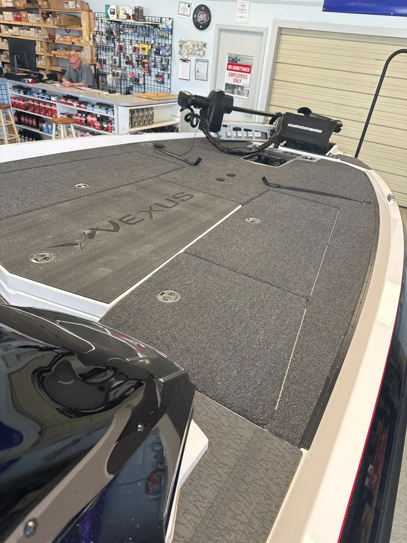 Slide: The Image of 2025 Vexus VXs21 boat with gray deck and Humminbird equipment. - 21