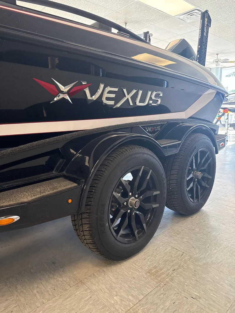 Slide: The Image of 2025 Vexus VXs21 boat with sleek black wheels. - 7