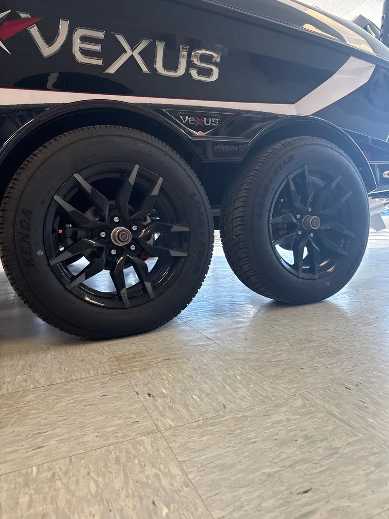 Slide: The Image of Black wheels of a 2025 Vexus VXs21 boat trailer. - 9