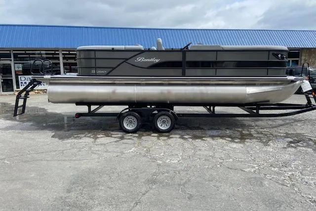 The Image of 2025 Bentley Pontoons Legacy 220 Navigator on trailer, parked outdoors. - 1