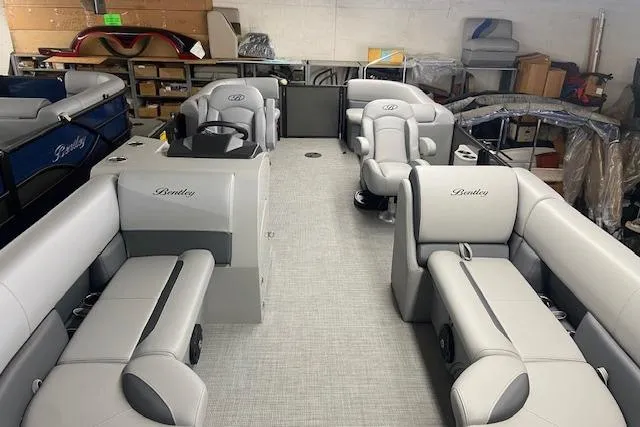 Slide: The Image of 2025 Bentley Pontoons Legacy 220 Navigator interior with luxurious seating and modern design. - 5