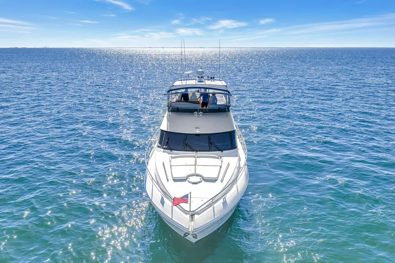 Slide: The Image of 2001 Neptunus 56 Flybridge yacht cruising on open sea under clear blue sky. - 10