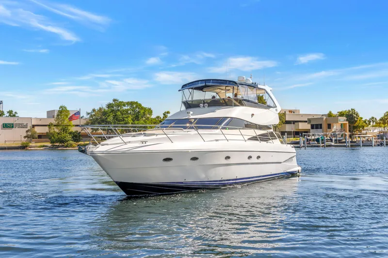Slide: The Image of 2001 Neptunus 56 Flybridge yacht cruising on a sunny day near a marina. - 20