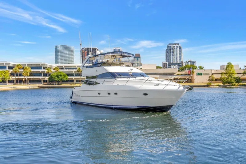 Slide: The Image of 2001 Neptunus 56 Flybridge yacht cruising near urban waterfront skyline. - 23