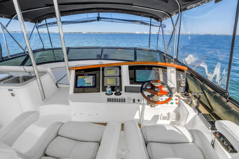 Slide: The Image of Flybridge helm of 2001 Neptunus 56 yacht with navigation equipment and ocean view. - 24