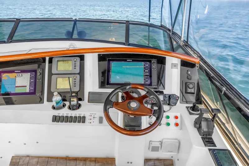 Slide: The Image of Helm of 2001 Neptunus 56 Flybridge yacht with navigation instruments and steering wheel. - 25