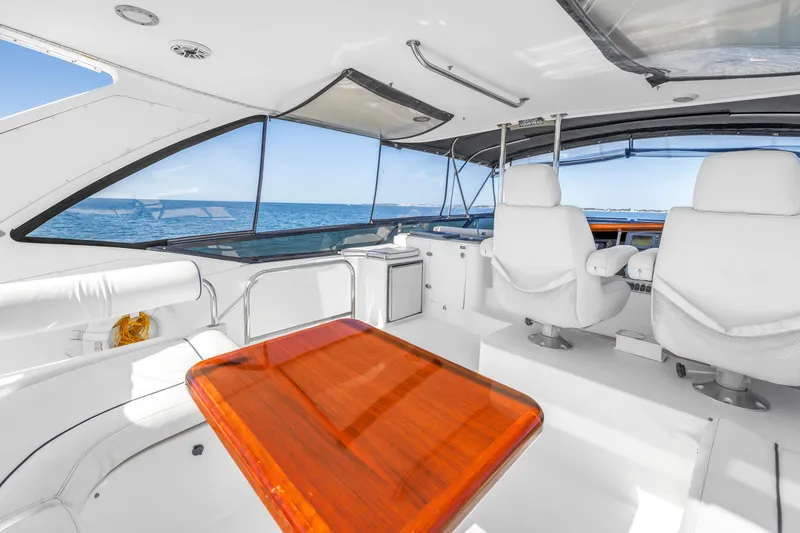 Slide: The Image of Luxurious 2001 Neptunus 56 Flybridge yacht interior with ocean view and elegant seating. - 28