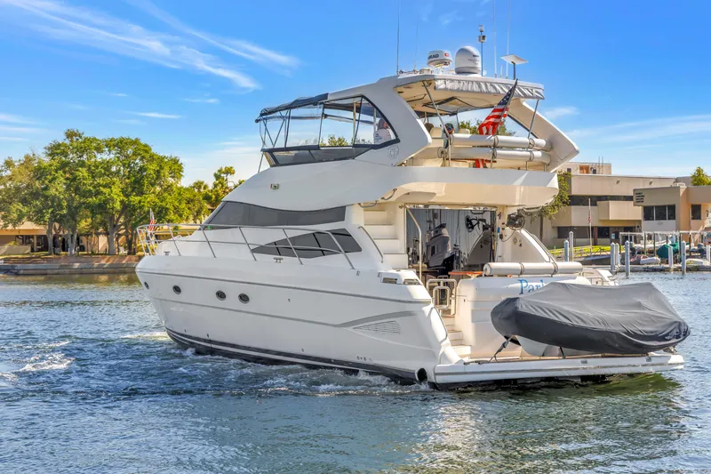 Slide: The Image of 2001 Neptunus 56 Flybridge yacht cruising on a sunny day near a marina. - 3