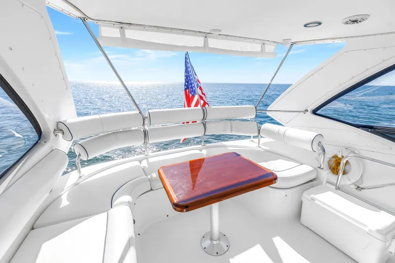 Slide: The Image of Luxurious 2001 Neptunus 56 Flybridge yacht interior with ocean view and American flag. - 30