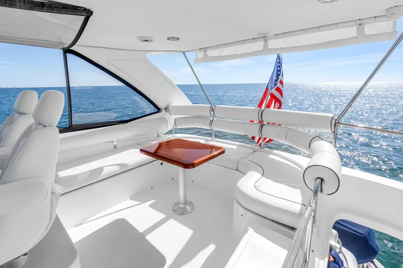 Slide: The Image of Luxurious 2001 Neptunus 56 Flybridge yacht interior with ocean view and American flag. - 31