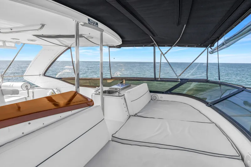 Slide: The Image of Luxurious 2001 Neptunus 56 Flybridge yacht interior with ocean view and elegant seating. - 34