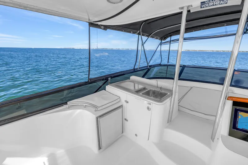 Slide: The Image of Flybridge view of 2001 Neptunus 56 yacht with ocean backdrop. - 37