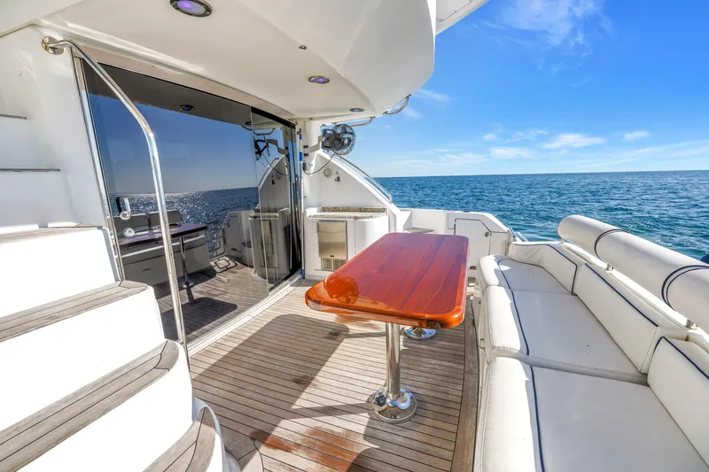 Slide: The Image of Luxurious 2001 Neptunus 56 Flybridge yacht deck with ocean view and elegant seating. - 41