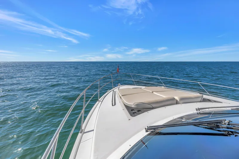 Slide: The Image of Neptunus 56 Flybridge yacht cruising on open sea under clear blue sky. - 44