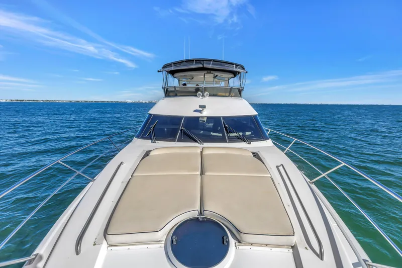 Slide: The Image of 2001 Neptunus 56 Flybridge yacht cruising on open sea under clear blue sky. - 46