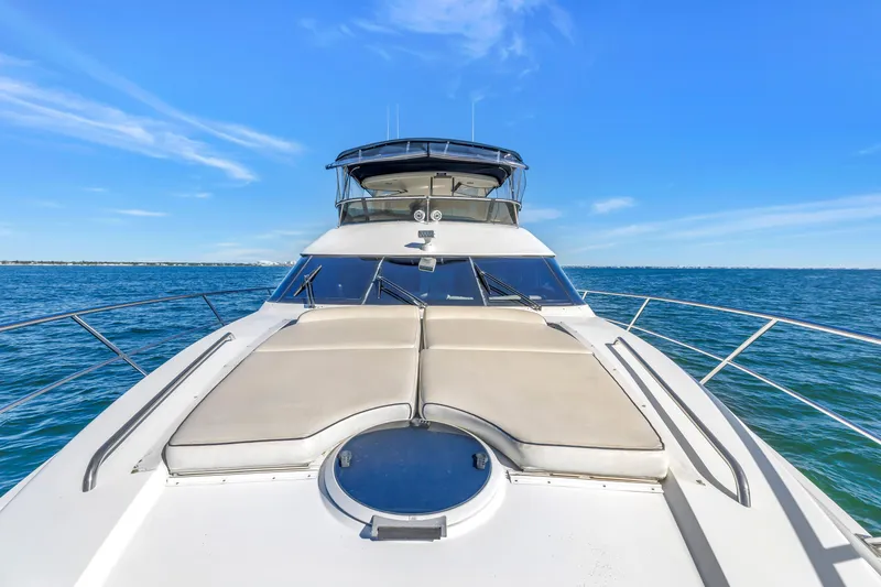 Slide: The Image of 2001 Neptunus 56 Flybridge yacht cruising on open water under clear blue skies. - 47