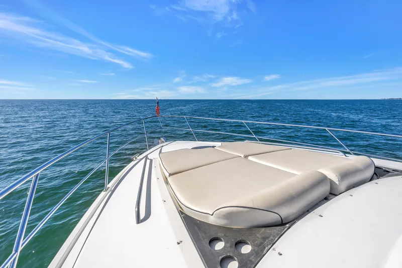 Slide: The Image of Bow view of 2001 Neptunus 56 Flybridge yacht on open sea under clear blue sky. - 49