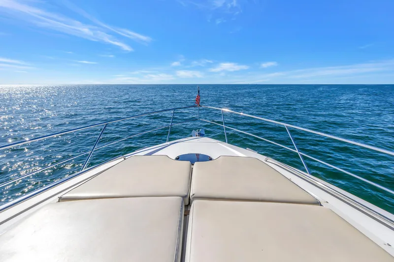 Slide: The Image of Bow view of 2001 Neptunus 56 Flybridge yacht cruising on open sea under clear blue sky. - 50