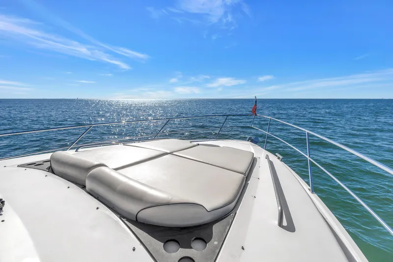 Slide: The Image of Bow view of 2001 Neptunus 56 Flybridge yacht on open sea under clear blue sky. - 51
