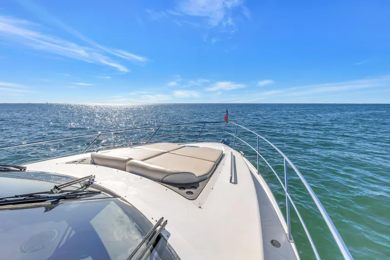 Slide: The Image of 2001 Neptunus 56 Flybridge yacht cruising on open sea under clear blue sky. - 52