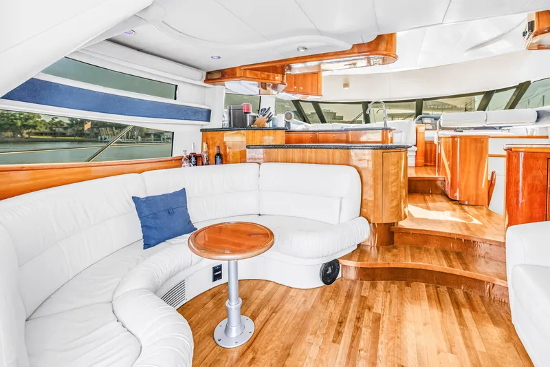 Slide: The Image of Luxurious interior of 2001 Neptunus 56 Flybridge yacht with elegant wood and white leather seating. - 54
