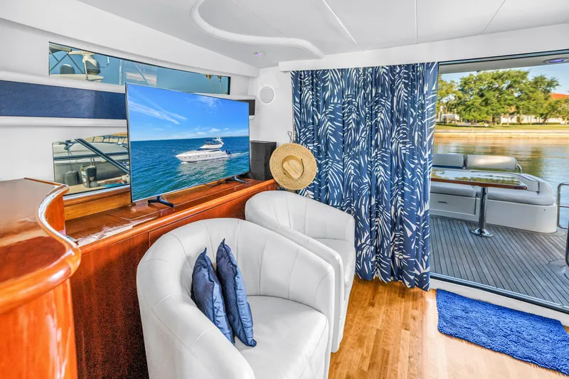 Slide: The Image of Luxurious 2001 Neptunus 56 Flybridge yacht interior with elegant seating and scenic view. - 55