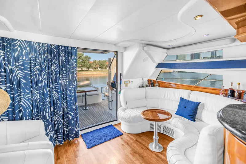 Slide: The Image of Luxurious interior of 2001 Neptunus 56 Flybridge yacht with elegant seating and scenic view. - 56