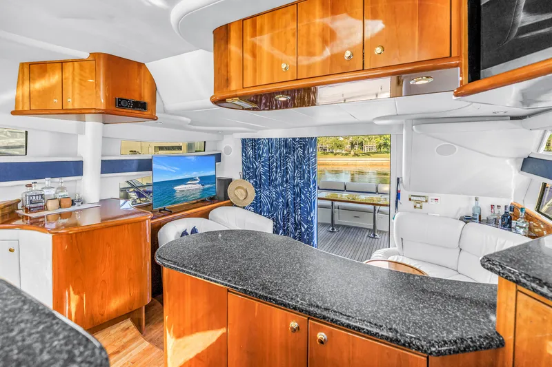 Slide: The Image of Luxurious interior of 2001 Neptunus 56 Flybridge yacht with elegant wood finishes. - 57