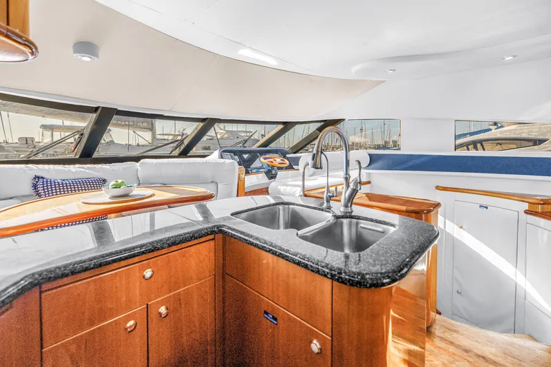 Slide: The Image of Luxurious interior of 2001 Neptunus 56 Flybridge yacht with modern kitchen and seating area. - 59