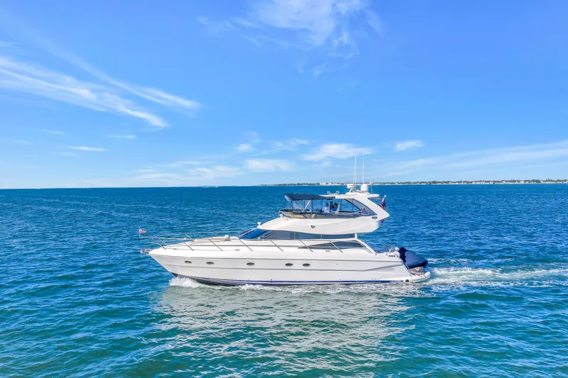 Slide: The Image of 2001 Neptunus 56 Flybridge yacht cruising on open blue waters under clear skies. - 6