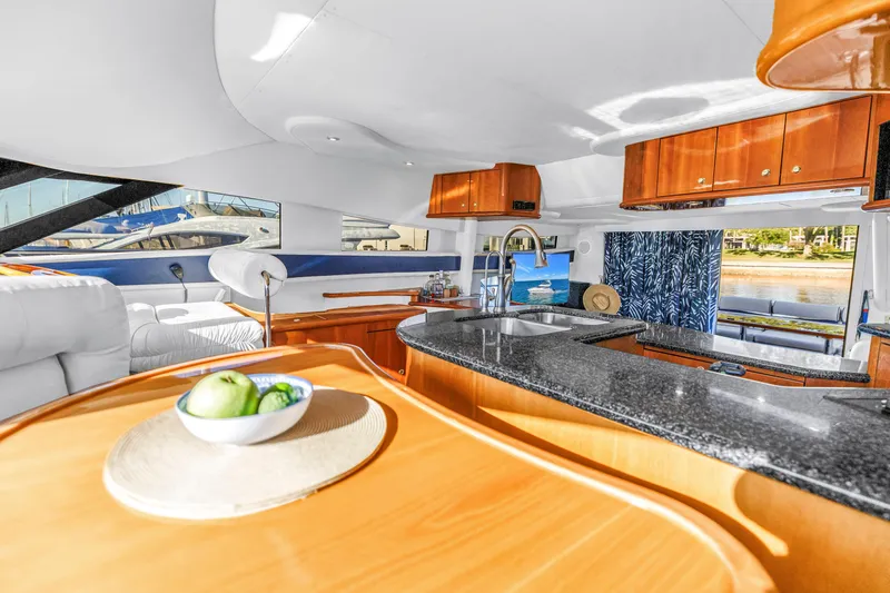 Slide: The Image of Luxurious interior of 2001 Neptunus 56 Flybridge yacht with modern kitchen and scenic views. - 62