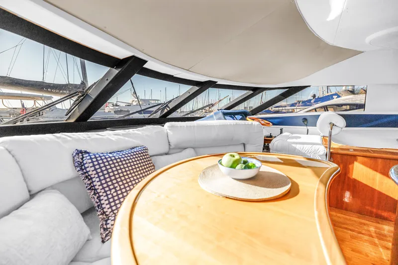 Slide: The Image of Luxurious interior of 2001 Neptunus 56 Flybridge yacht with elegant seating and panoramic windows. - 63