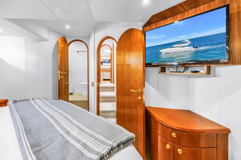 Slide: The Image of Luxurious 2001 Neptunus 56 Flybridge yacht interior with wood accents and flat-screen TV. - 70