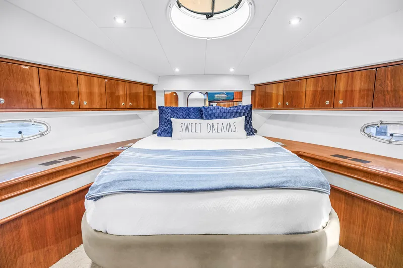 Slide: The Image of Luxurious bedroom interior of 2001 Neptunus 56 Flybridge yacht with elegant wood cabinetry. - 72
