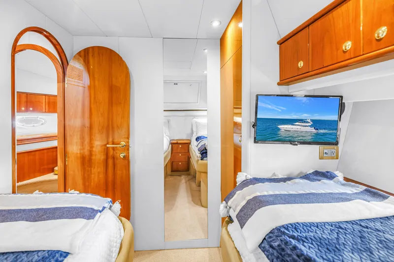 Slide: The Image of Luxurious cabin interior of 2001 Neptunus 56 Flybridge yacht with wooden finishes and TV. - 74