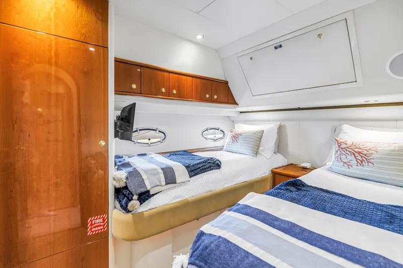 Slide: The Image of Luxurious 2001 Neptunus 56 Flybridge yacht cabin with twin beds and elegant wood finishes. - 75