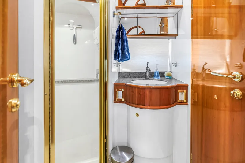 Slide: The Image of Luxurious bathroom on 2001 Neptunus 56 Flybridge yacht with elegant wood and gold accents. - 76