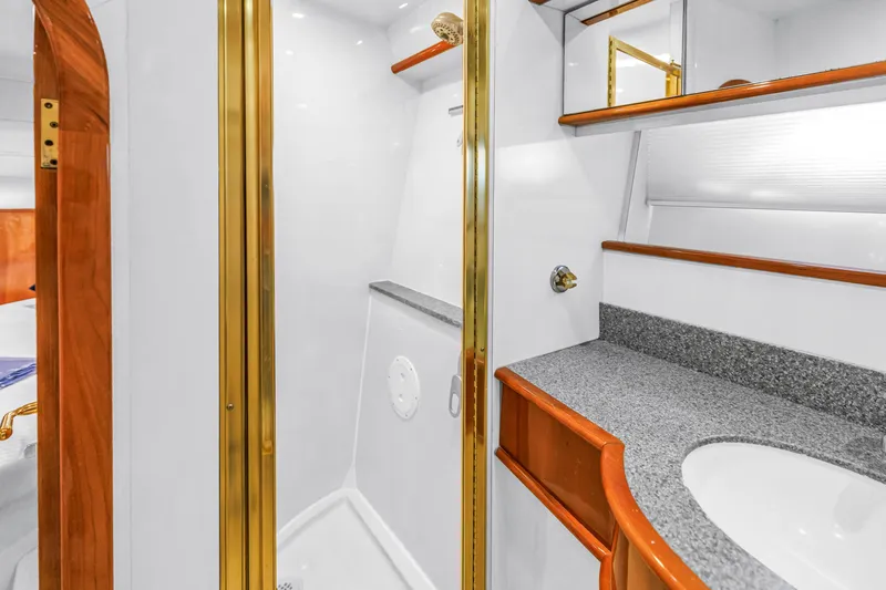 Slide: The Image of Luxurious bathroom interior of 2001 Neptunus 56 Flybridge yacht with elegant wood and gold accents. - 78