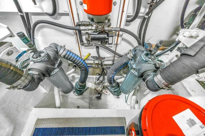 Slide: The Image of Engine room of 2001 Neptunus 56 Flybridge yacht, showcasing mechanical components and hoses. - 84
