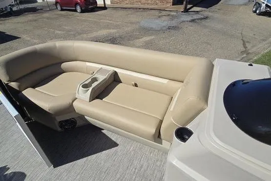 Slide: The Image of 2026 Godfrey Xperience 2286 boat interior with beige seating and cup holders. - 3