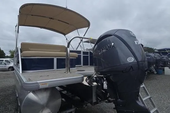 Slide: The Image of 2026 Godfrey Xperience 2286 pontoon boat with Yamaha outboard motor, beige seating, and canopy. - 4