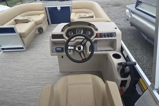 Slide: The Image of 2026 Godfrey Xperience 2286 pontoon boat interior with beige seating and modern helm controls. - 6