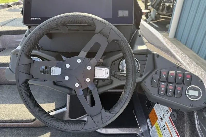 Slide: The Image of Steering wheel and dashboard of 2026 Skeeter ZXE20 boat with control panel and display. - 10