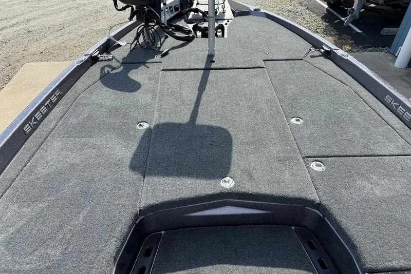 Slide: The Image of 2026 Skeeter ZXE20 boat deck with gray carpeting and fishing equipment. - 14