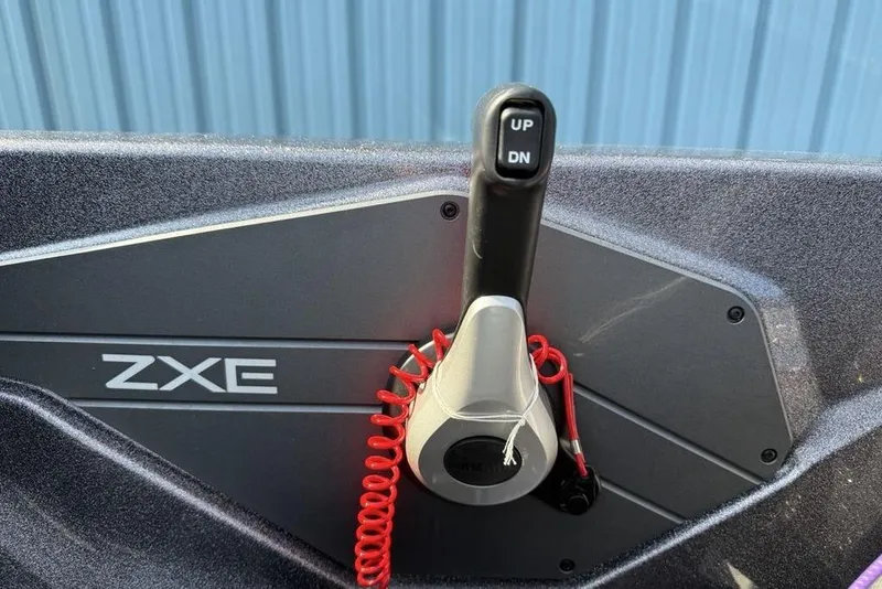 Slide: The Image of Control panel of 2026 Skeeter ZXE20 boat with throttle lever and red safety cord. - 16