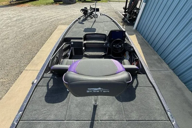 Slide: The Image of 2026 Skeeter ZXE20 boat interior with steering console and seating. - 18