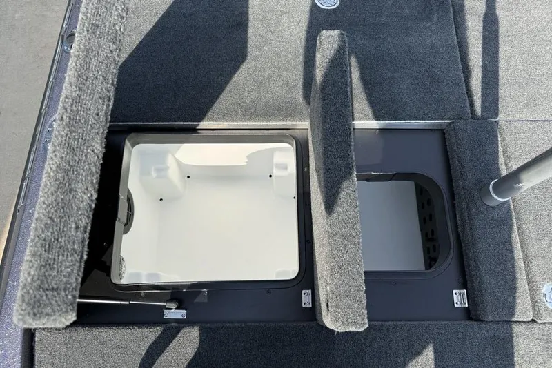 Slide: The Image of 2026 Skeeter ZXE20 boat storage compartments with open hatches, showcasing interior design. - 19