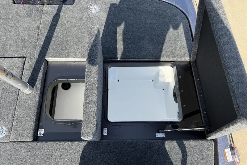 Slide: The Image of Open storage compartments on a 2026 Skeeter ZXE20 boat deck. - 23